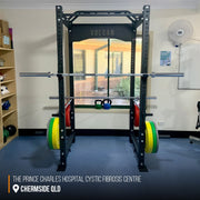commercial power cage with barbell and bumper plates