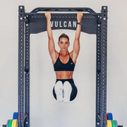 Commercial power cage with woman performing ab exercise